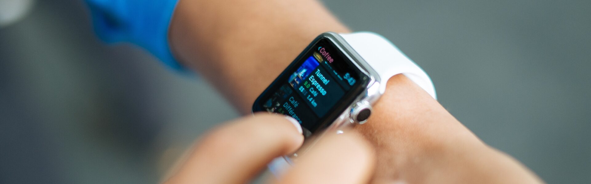 person wearing silver Apple Watch with white Sport Band